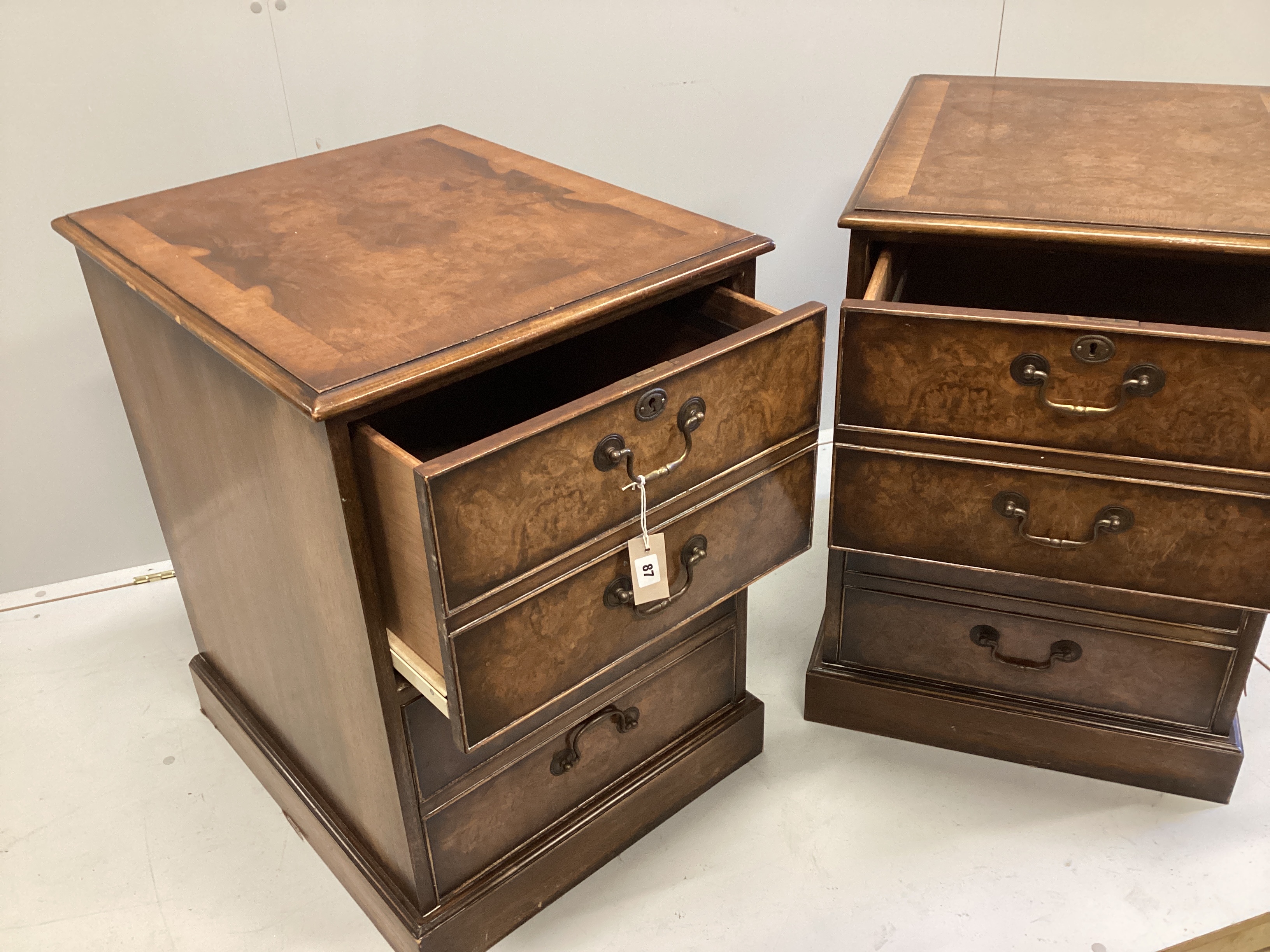 A pair of reproduction George III style banded walnut two drawer filing chests, width 54cm, depth 64cm, height 76cm